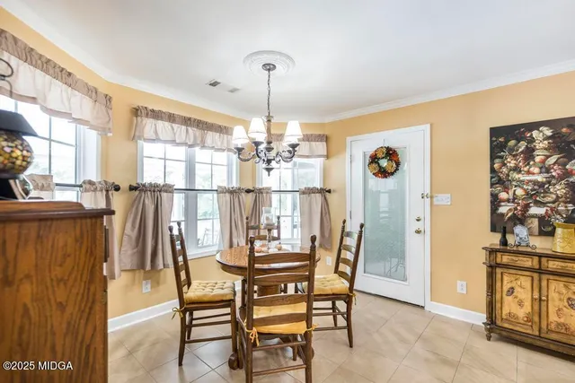 a dining room with furniture and window