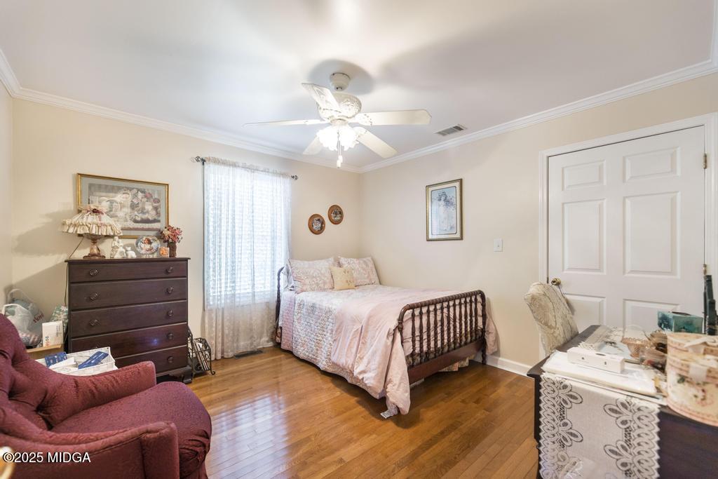 674 Mt Paran Road Lizella, GA 31052 - Photo 19 of 45 a bedroom with a bed and a chandelier