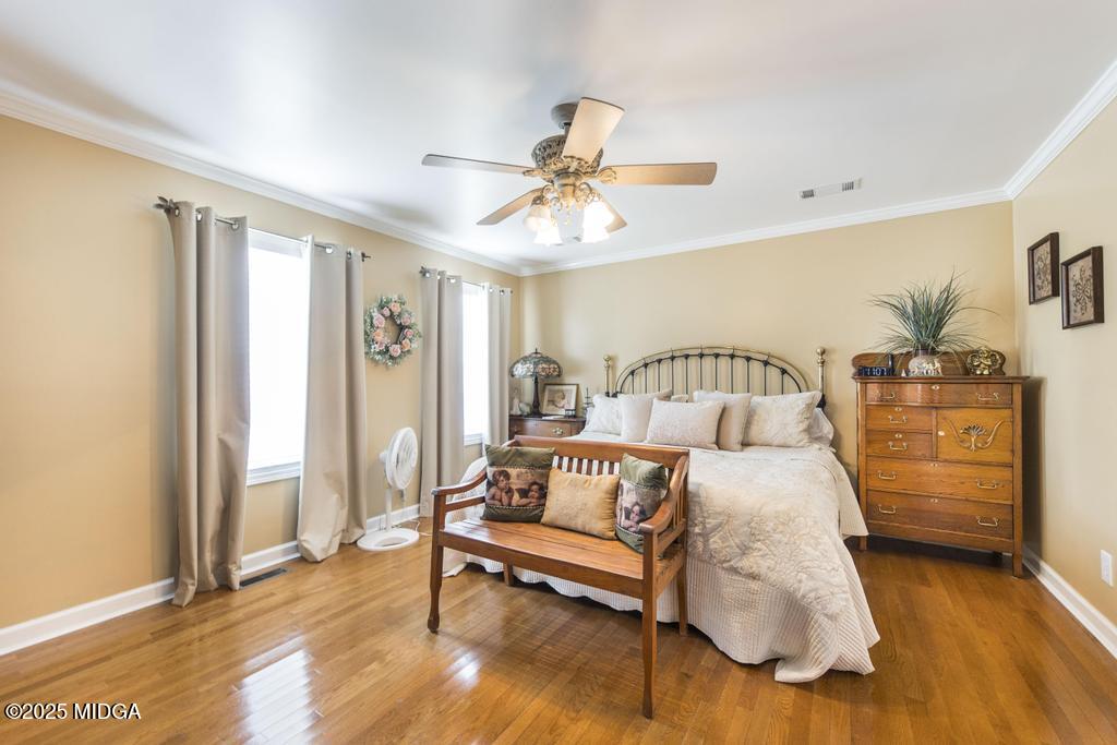 674 Mt Paran Road Lizella, GA 31052 - Photo 22 of 45 a bedroom with a bed and wooden floor