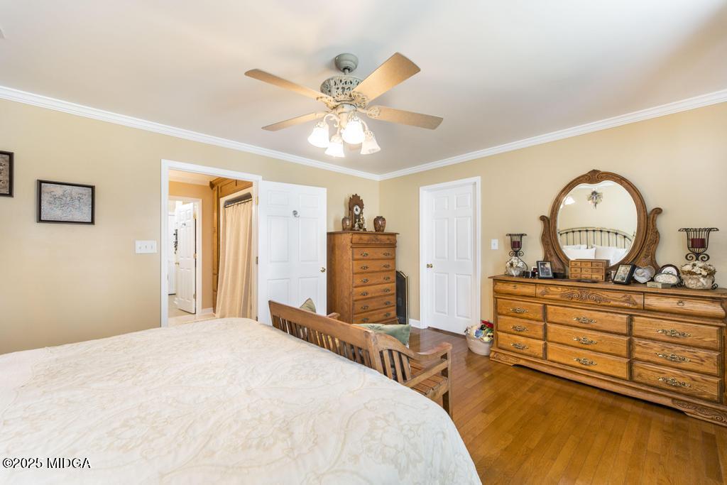 674 Mt Paran Road Lizella, GA 31052 - Photo 23 of 45 a bedroom with a bed and a chandelier