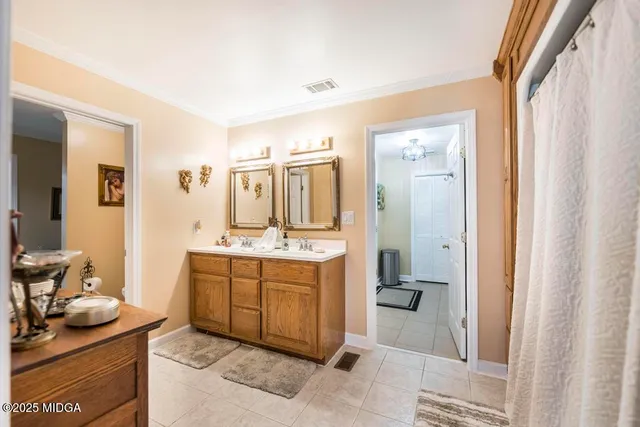 a spacious bathroom with a granite countertop sink and a mirror