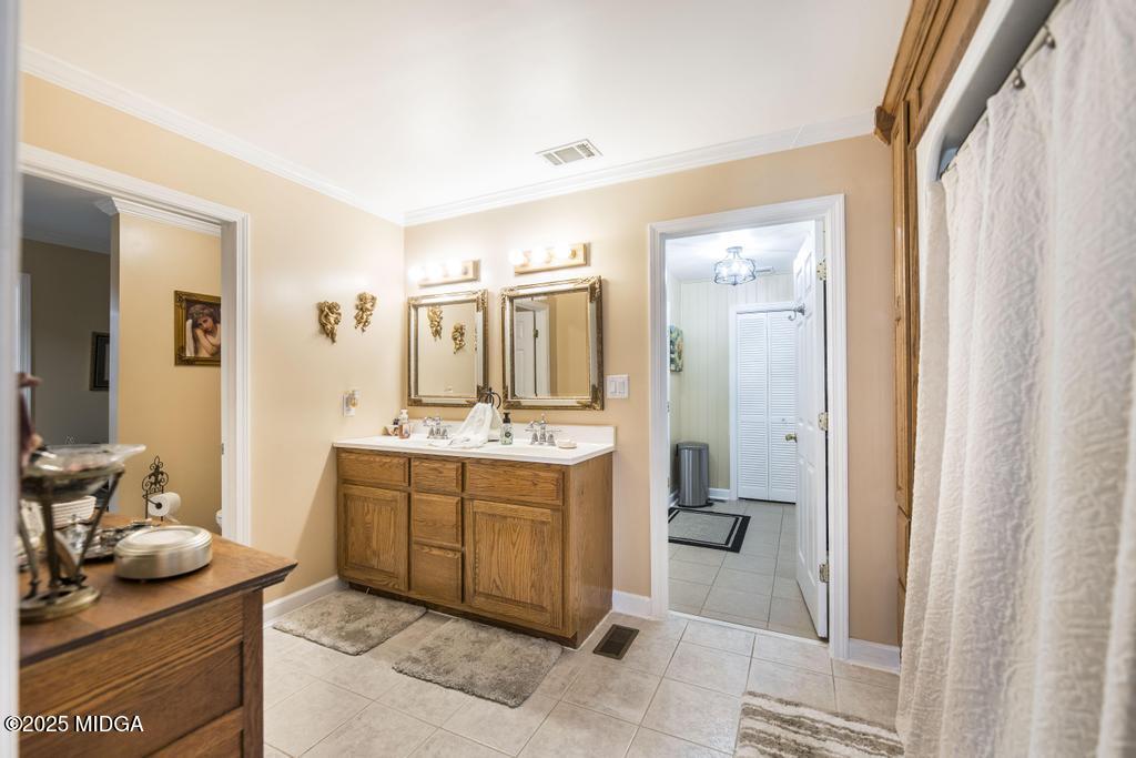 674 Mt Paran Road Lizella, GA 31052 - Photo 25 of 45 a spacious bathroom with a granite countertop sink and a mirror