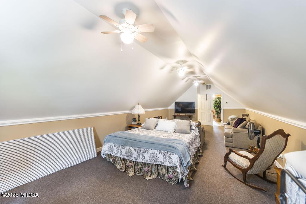 674 Mt Paran Road Lizella, GA 31052 - Photo 27 of 45 a bedroom with furniture and a chandelier