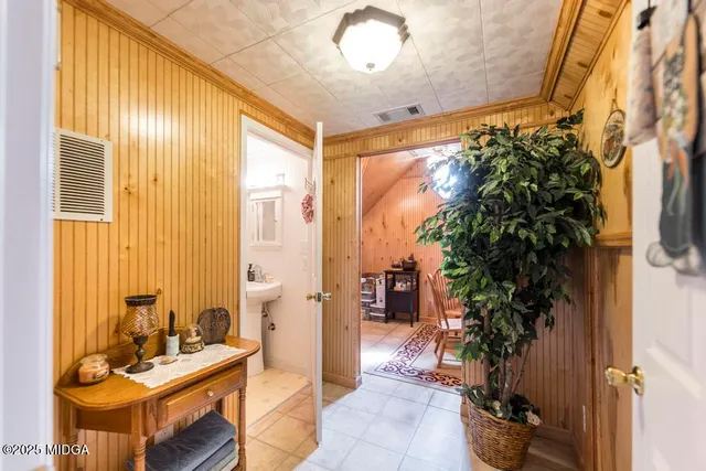 a living room with furniture and a potted plant