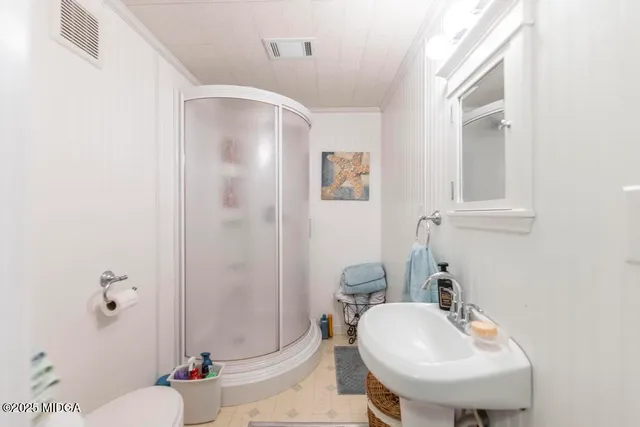 a bathroom with a sink toilet and shower