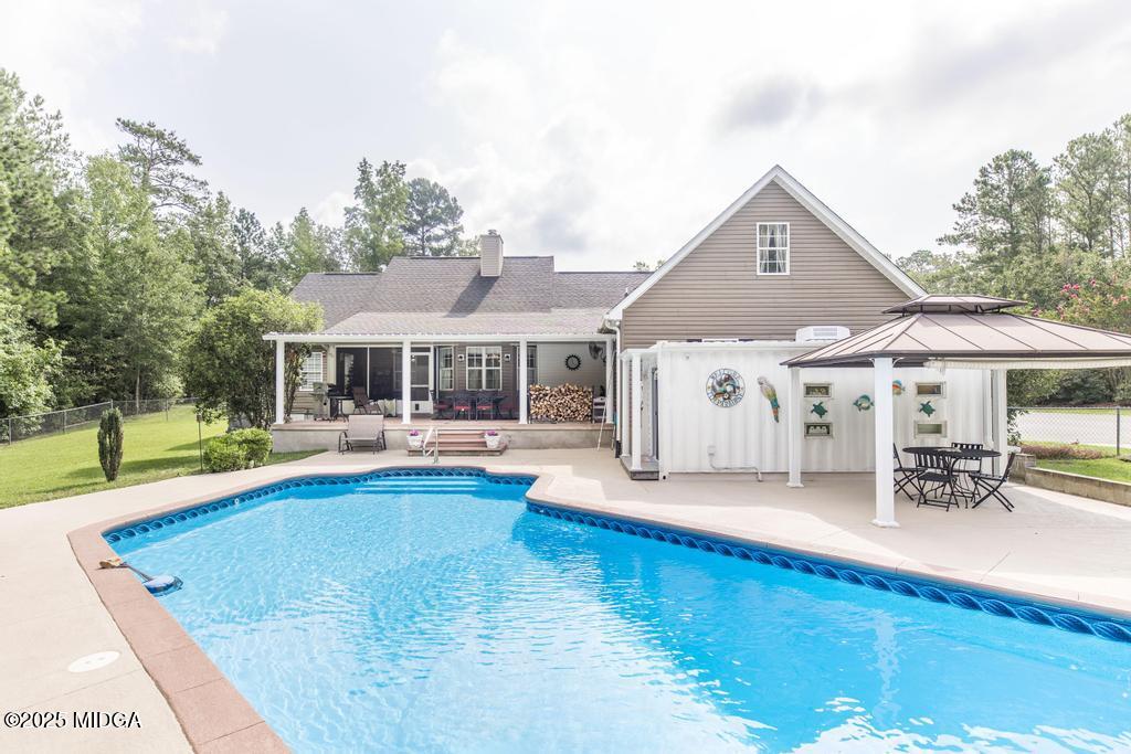 674 Mt Paran Road Lizella, GA 31052 - Photo 35 of 45 a front view of house with swimming pool yard and outdoor seating