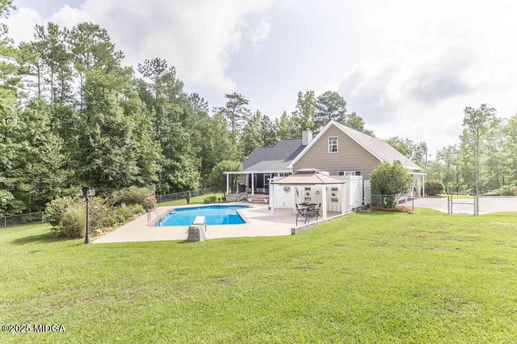 674 Mt Paran Road Lizella, GA 31052 - Photo 37 of 45 a view of a house with a big yard and large trees