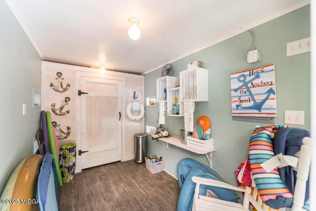 a bedroom with furniture and a refrigerator