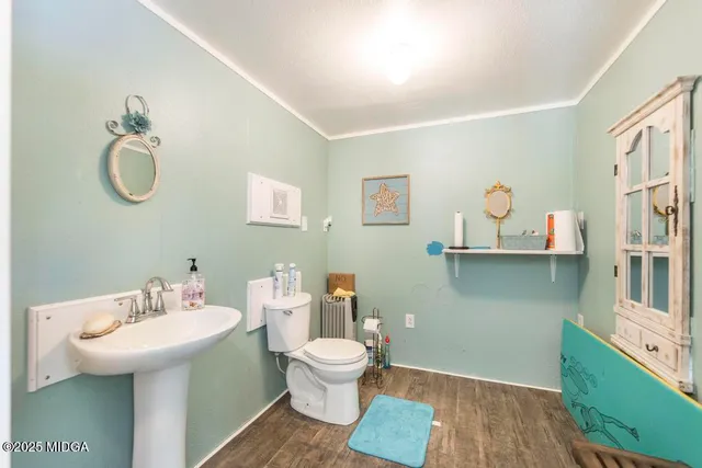 a bathroom with a toilet sink and mirror