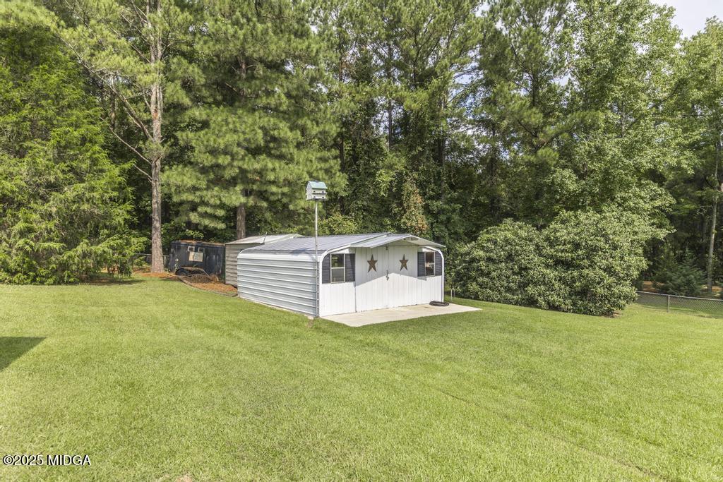 674 Mt Paran Road Lizella, GA 31052 - Photo 43 of 45 a white house with a big yard and large trees