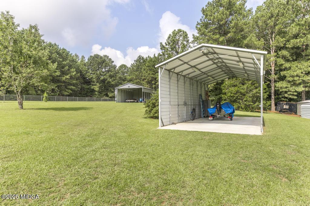 674 Mt Paran Road Lizella, GA 31052 - Photo 44 of 45 a view of a house with a backyard and a patio
