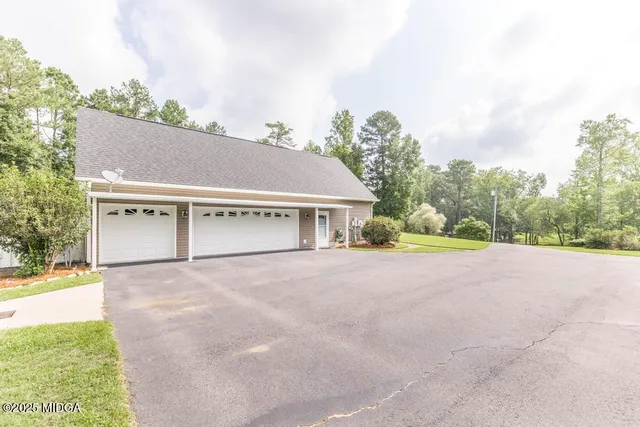 a view of house with outdoor space and garden