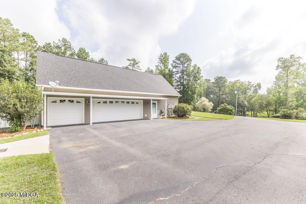 674 Mt Paran Road Lizella, GA 31052 - Photo 5 of 45 a view of house with outdoor space and garden
