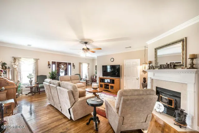 a living room with furniture a fireplace and a flat screen tv