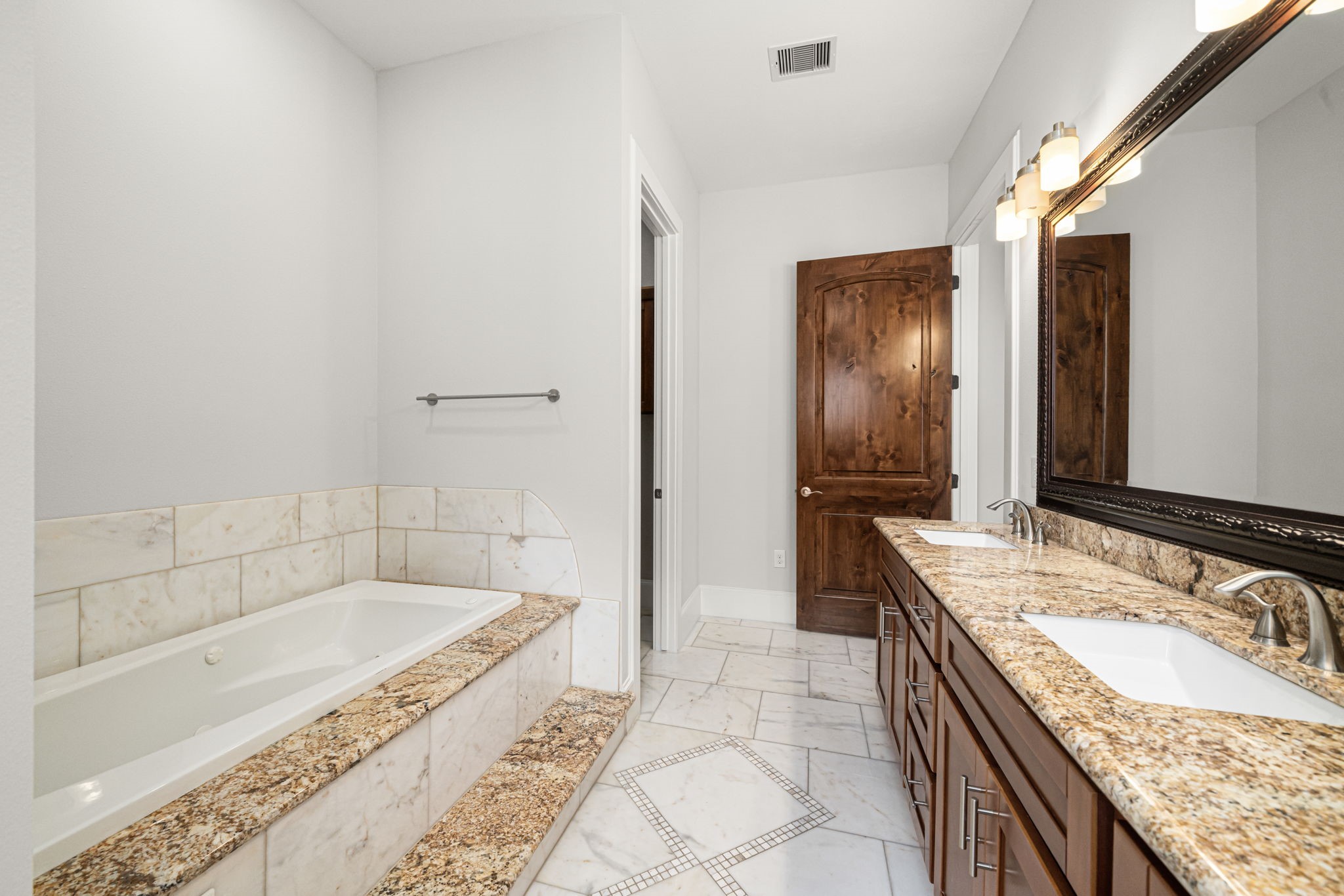 2022 Sabine Street Houston, TX 77007 - Photo 12 of 23 a spacious bathroom with a granite countertop tub sink and mirror