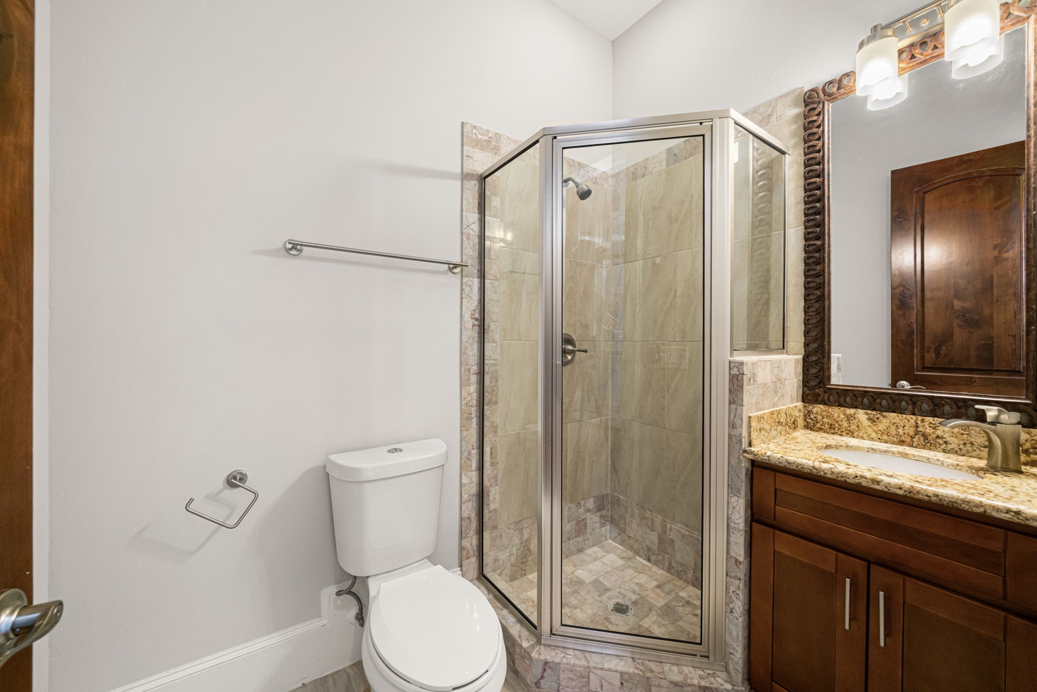 2022 Sabine Street Houston, TX 77007 - Photo 17 of 23 a bathroom with a granite countertop sink toilet and shower