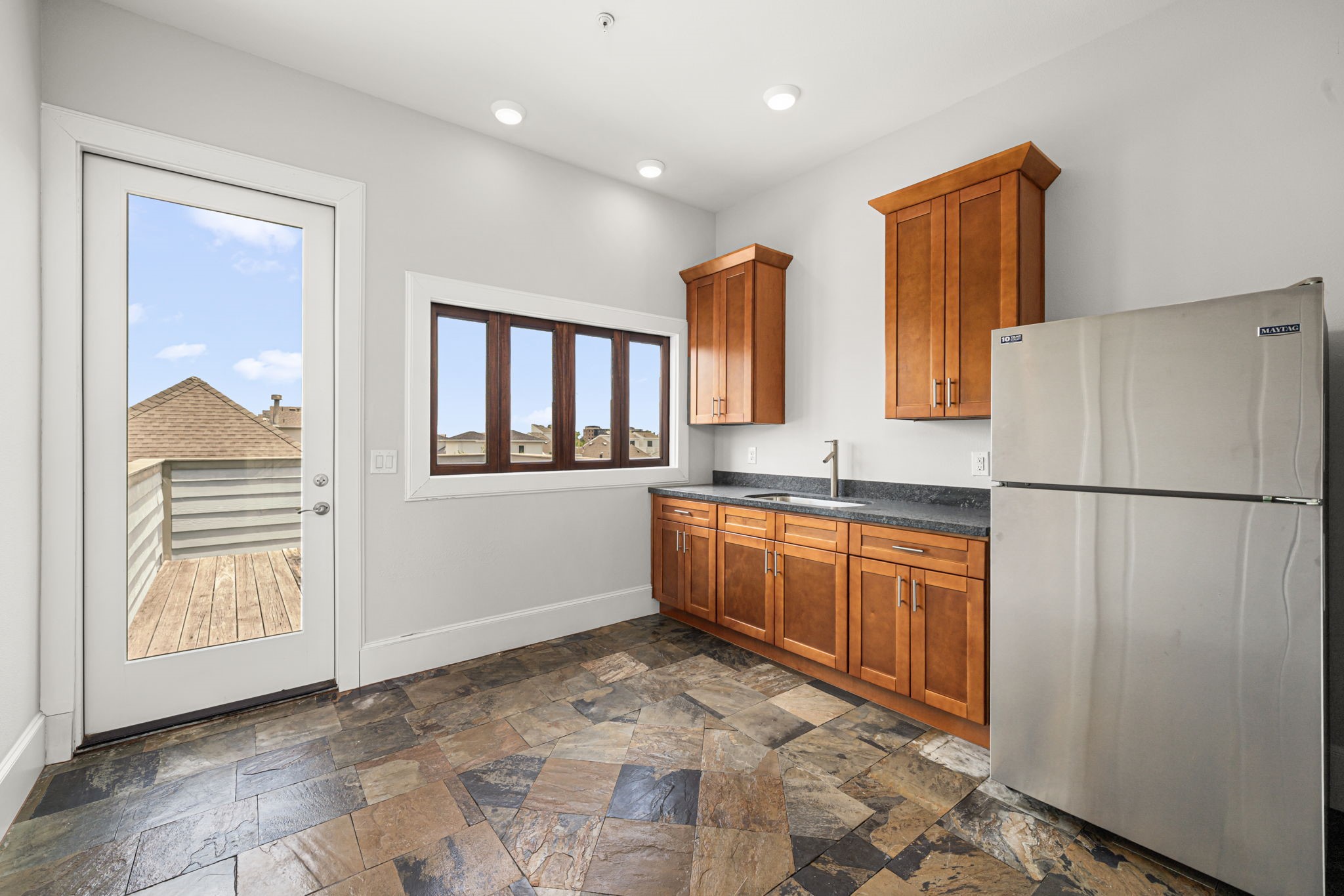2022 Sabine Street Houston, TX 77007 - Photo 18 of 23 a large kitchen with stainless steel appliances granite countertop a refrigerator and a sink