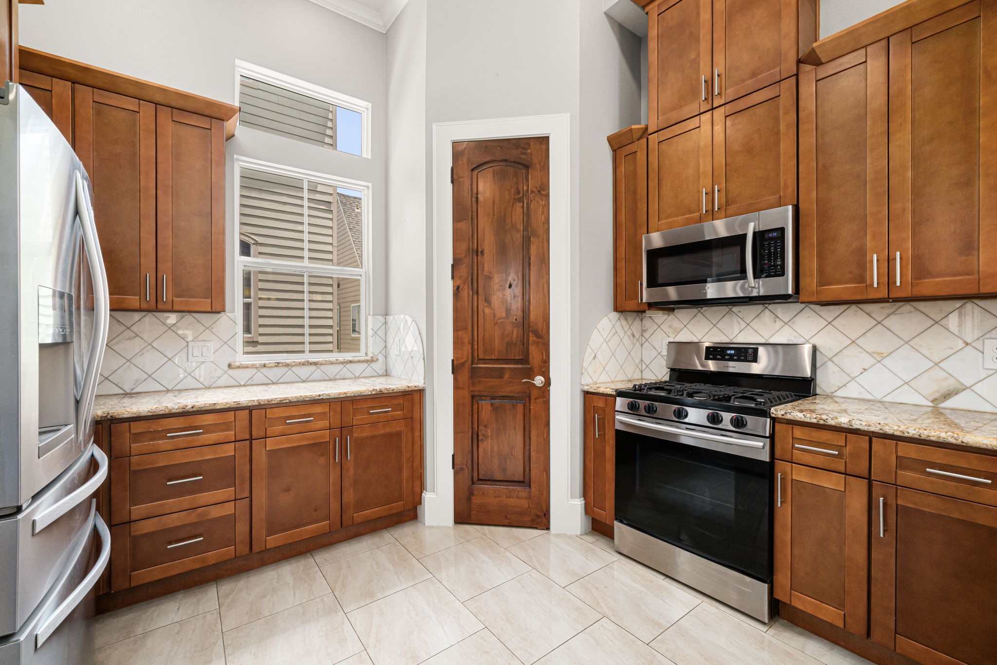 2022 Sabine Street Houston, TX 77007 - Photo 5 of 23 a kitchen with stainless steel appliances granite countertop a stove top oven microwave and refrigerator