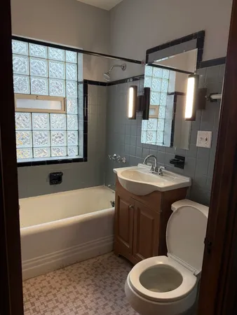 a bathroom with a sink a toilet and bathtub