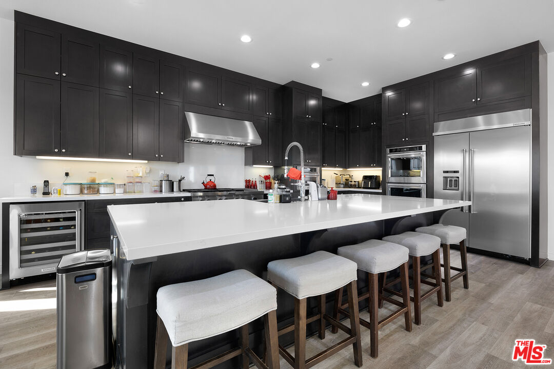 20234 Jubilee Way Porter Ranch, CA 91326 - Photo 7 of 30 a kitchen with a table and chairs in it