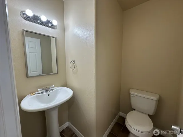 a bathroom with a sink a toilet and mirror