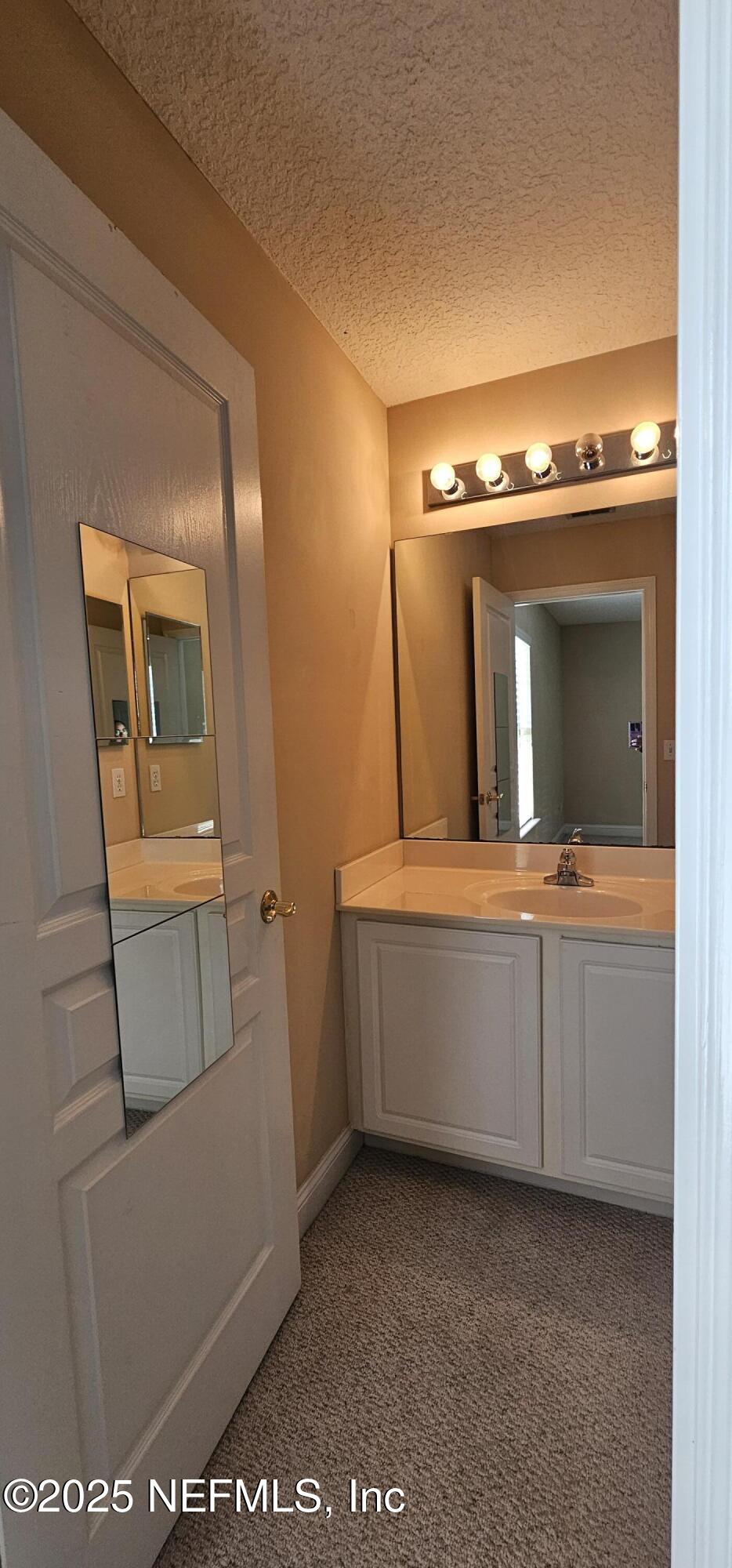 1741 Highland View Drive St. Augustine, FL 32092 - Photo 32 of 46 a bathroom with a sink and a mirror