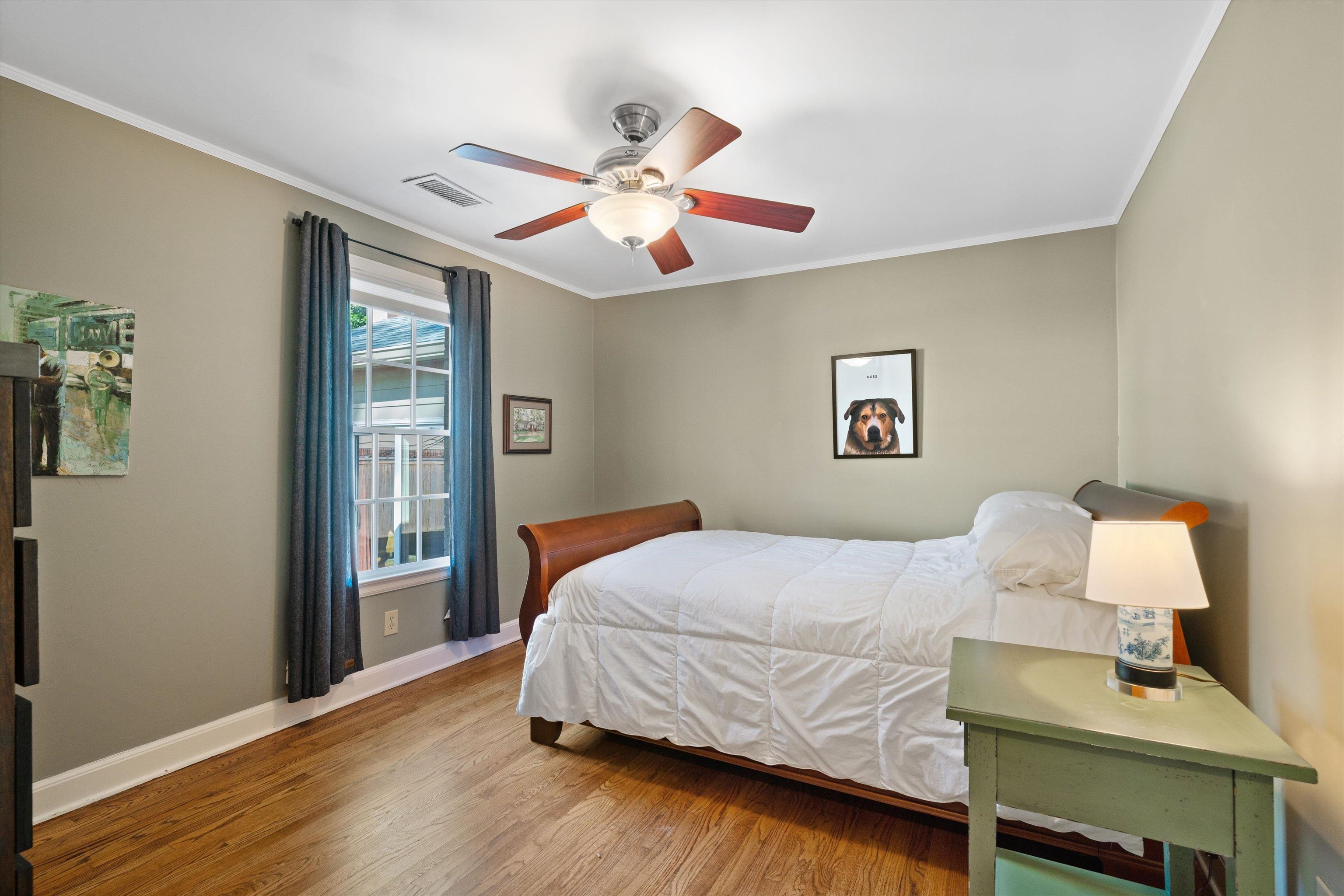567 South Yates Road Memphis, TN 38120 - Photo 15 of 20 a bedroom with a bed and wooden floor