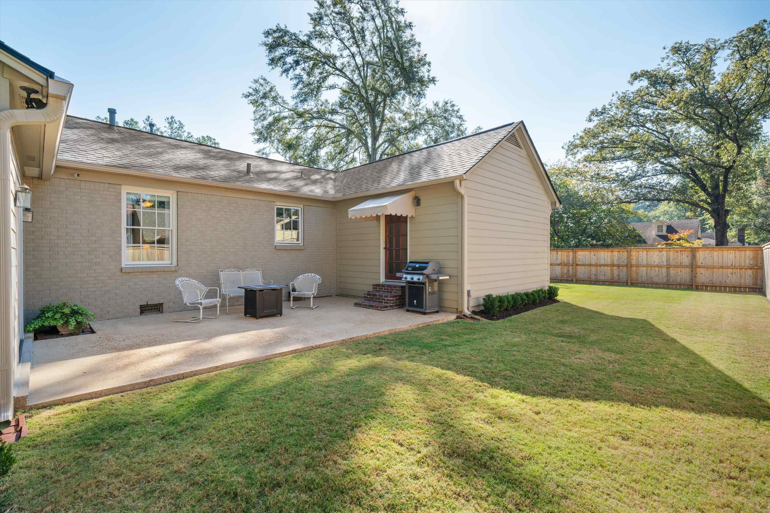 567 South Yates Road Memphis, TN 38120 - Photo 19 of 20 a view of a house with a patio and a yard