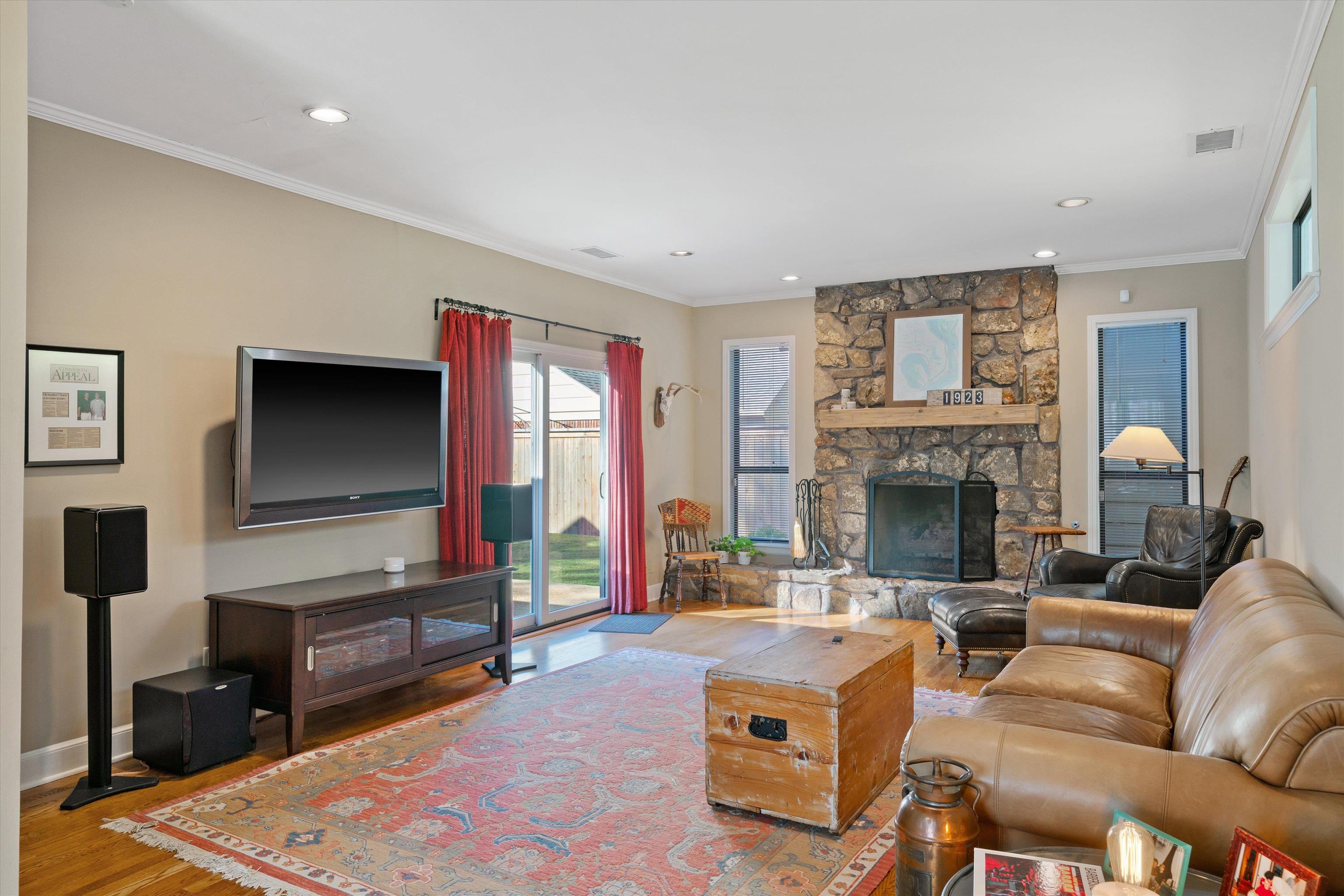 567 South Yates Road Memphis, TN 38120 - Photo 3 of 20 a living room with furniture a flat screen tv and a fireplace