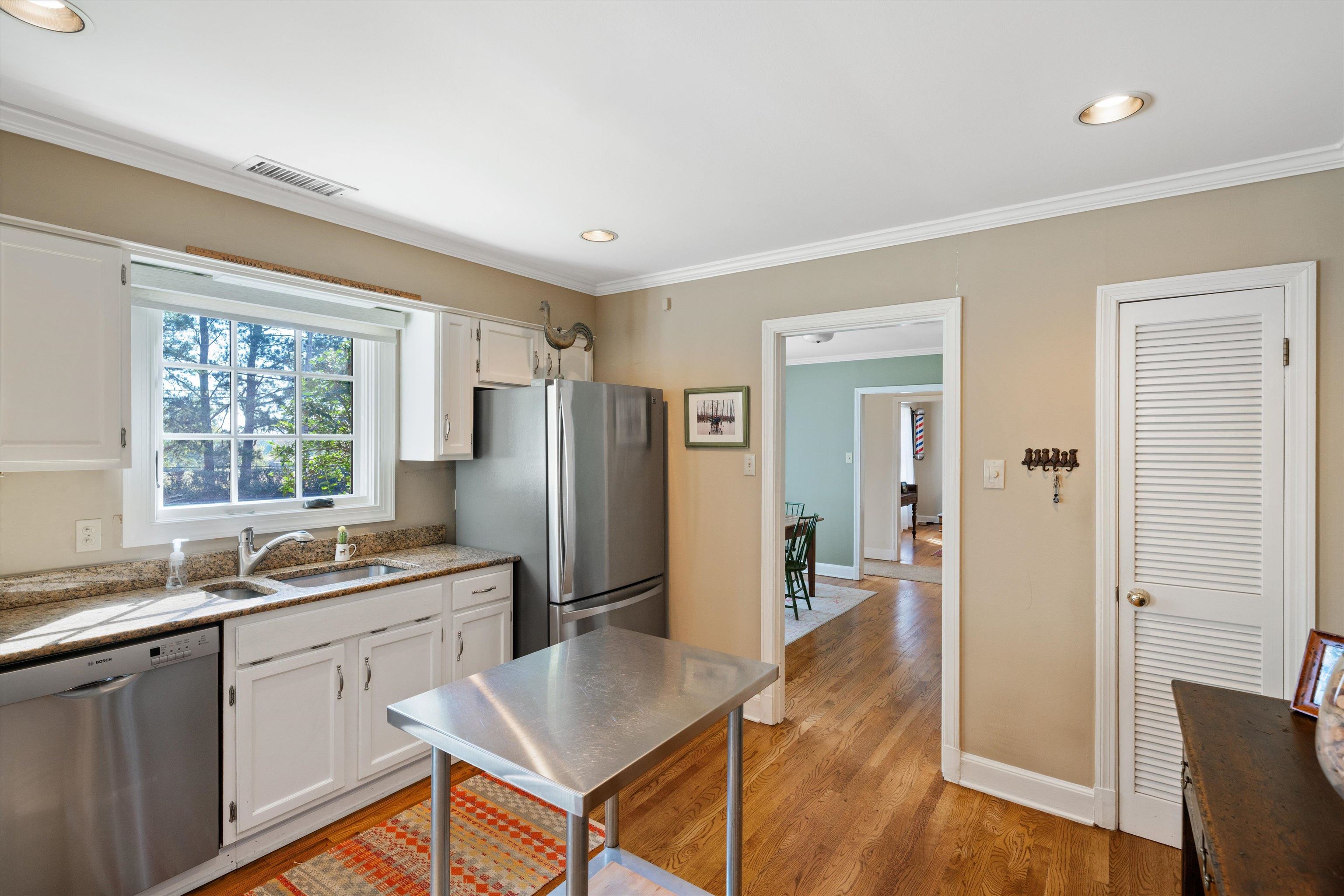 567 South Yates Road Memphis, TN 38120 - Photo 8 of 20 a kitchen with refrigerator cabinets and wooden floor