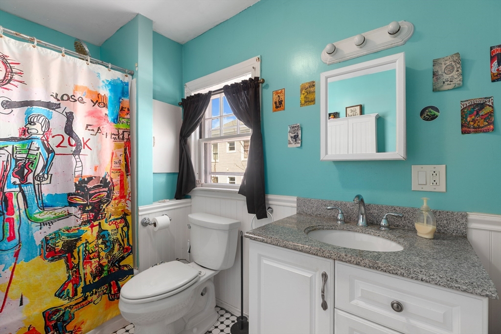 22 Montgomery Street Fall River, MA 02720 - Photo 15 of 22 a bathroom with a granite countertop toilet sink and mirror