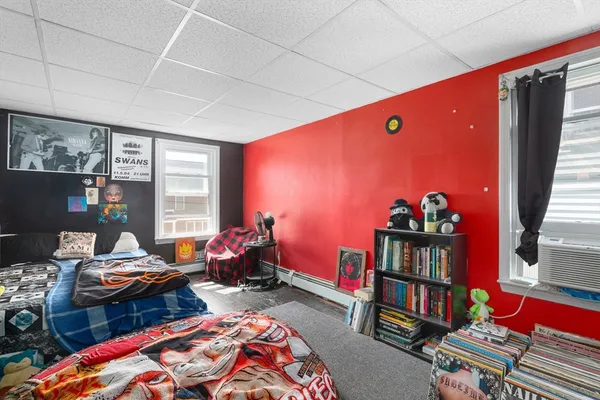 a bedroom with furniture and a book shelf