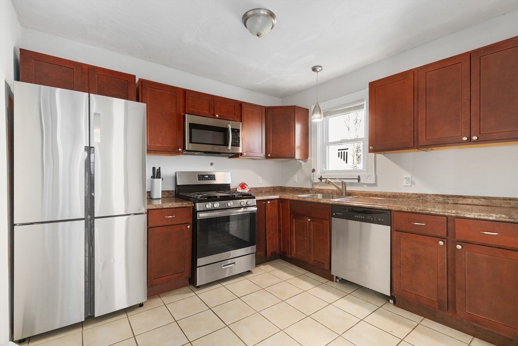 22 Montgomery Street Fall River, MA 02720 - Photo 2 of 22 a kitchen with stainless steel appliances granite countertop a refrigerator sink and stove