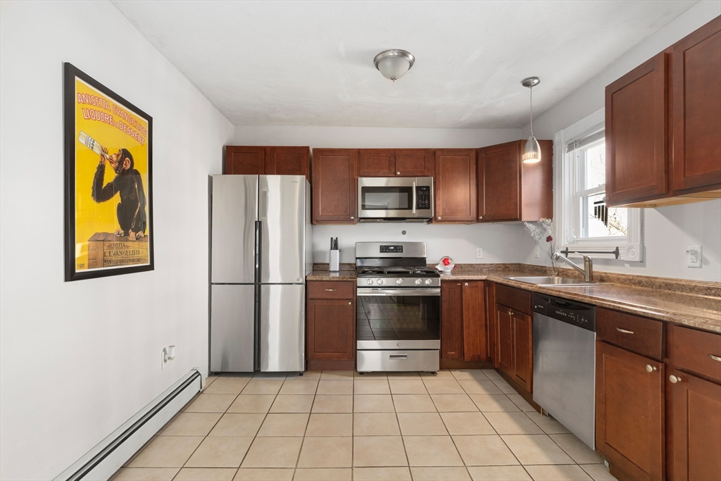 22 Montgomery Street Fall River, MA 02720 - Photo 3 of 22 a kitchen with stainless steel appliances granite countertop a refrigerator sink and stove