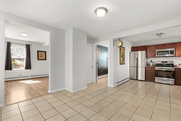 a open kitchen with cabinets and stainless steel appliances