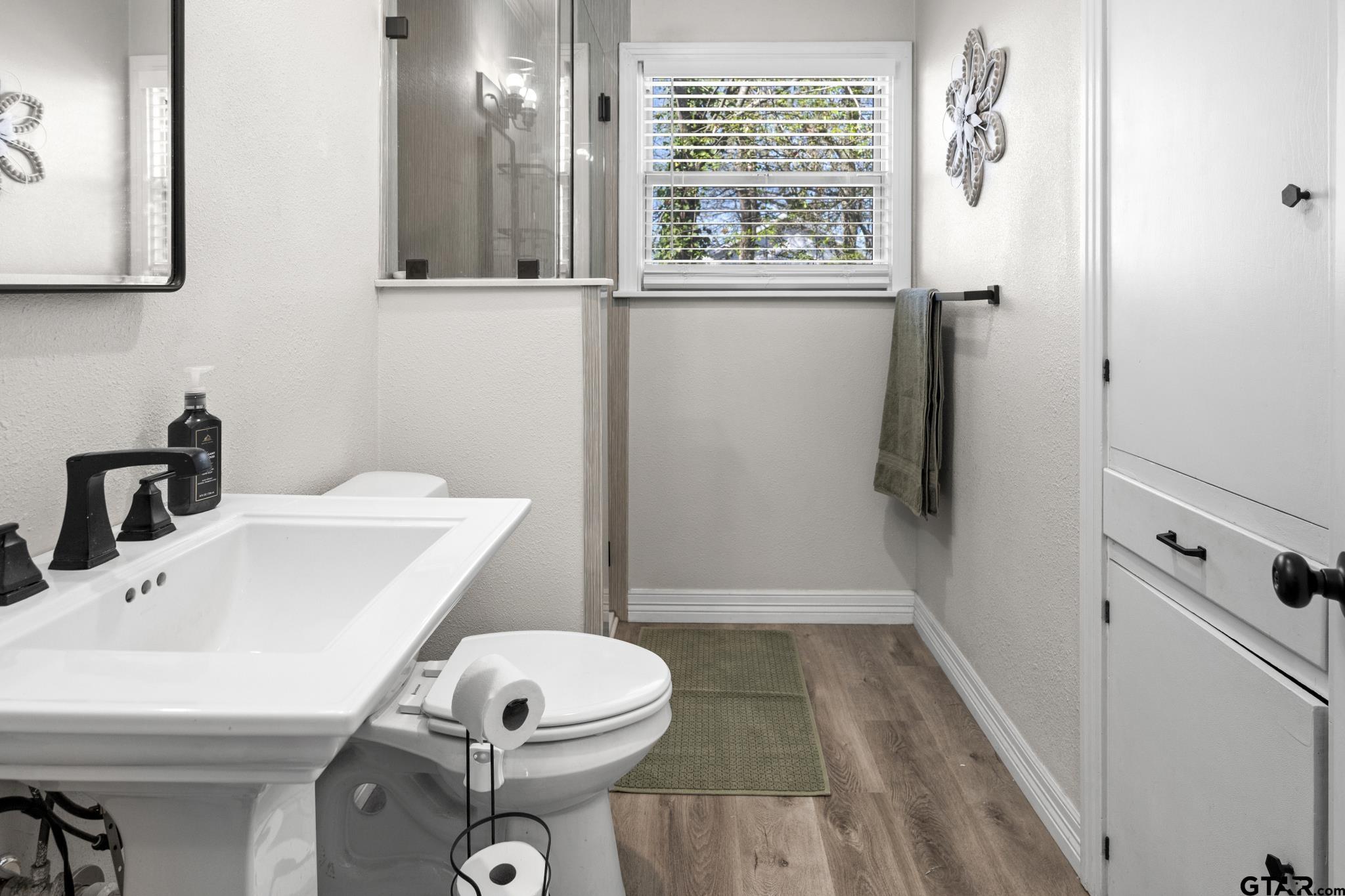 290 Lynch Street Hawkins, TX 75765 - Photo 15 of 36 a bathroom with a sink toilet and shower