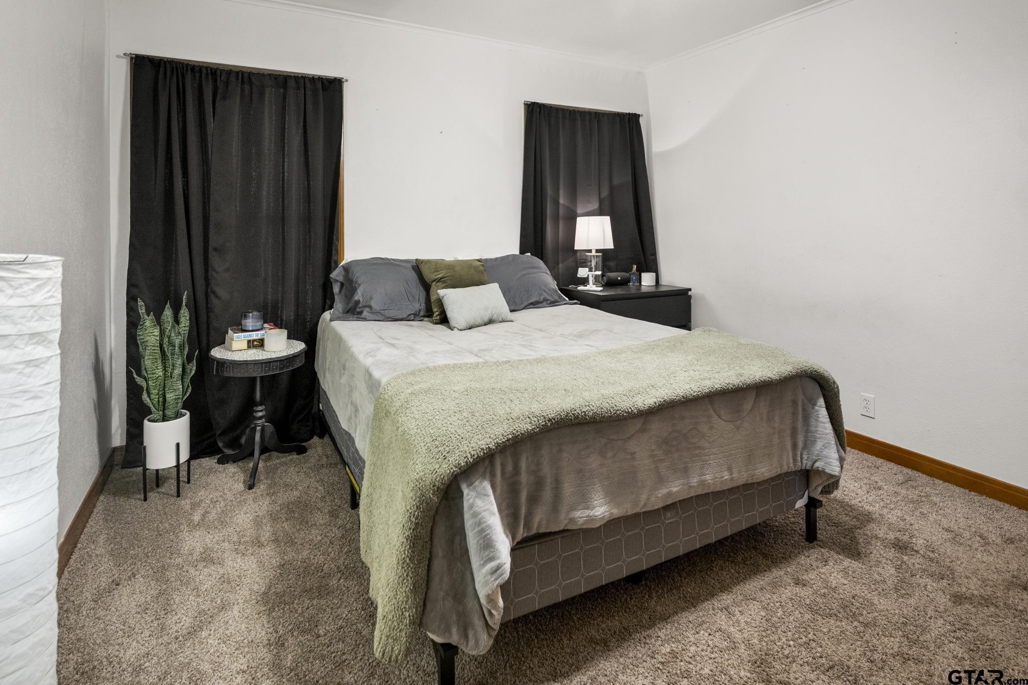 290 Lynch Street Hawkins, TX 75765 - Photo 18 of 36 a bedroom with a bed and chair