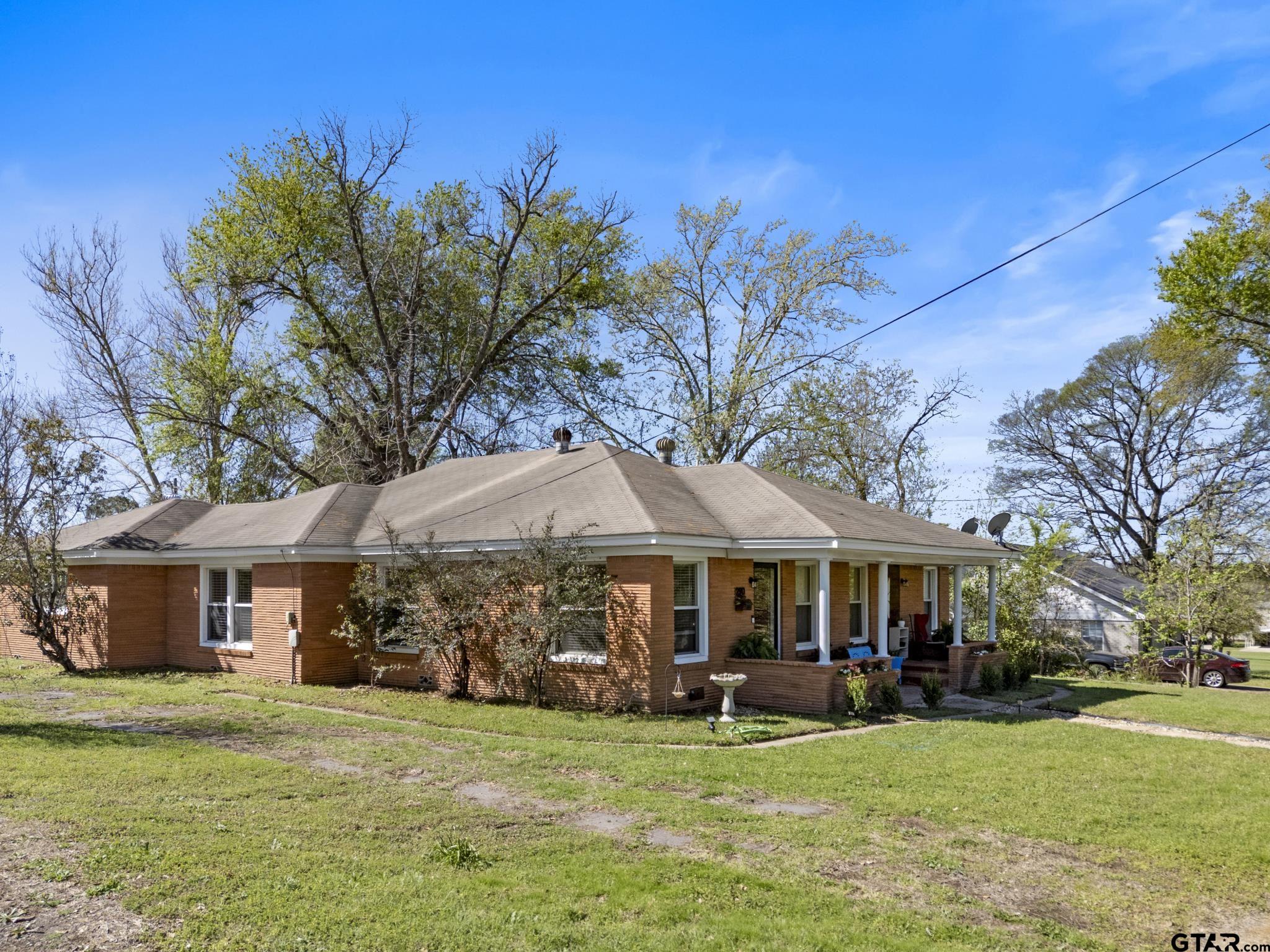 290 Lynch Street Hawkins, TX 75765 - Photo 28 of 36 a patio with a table and chairs under an umbrella