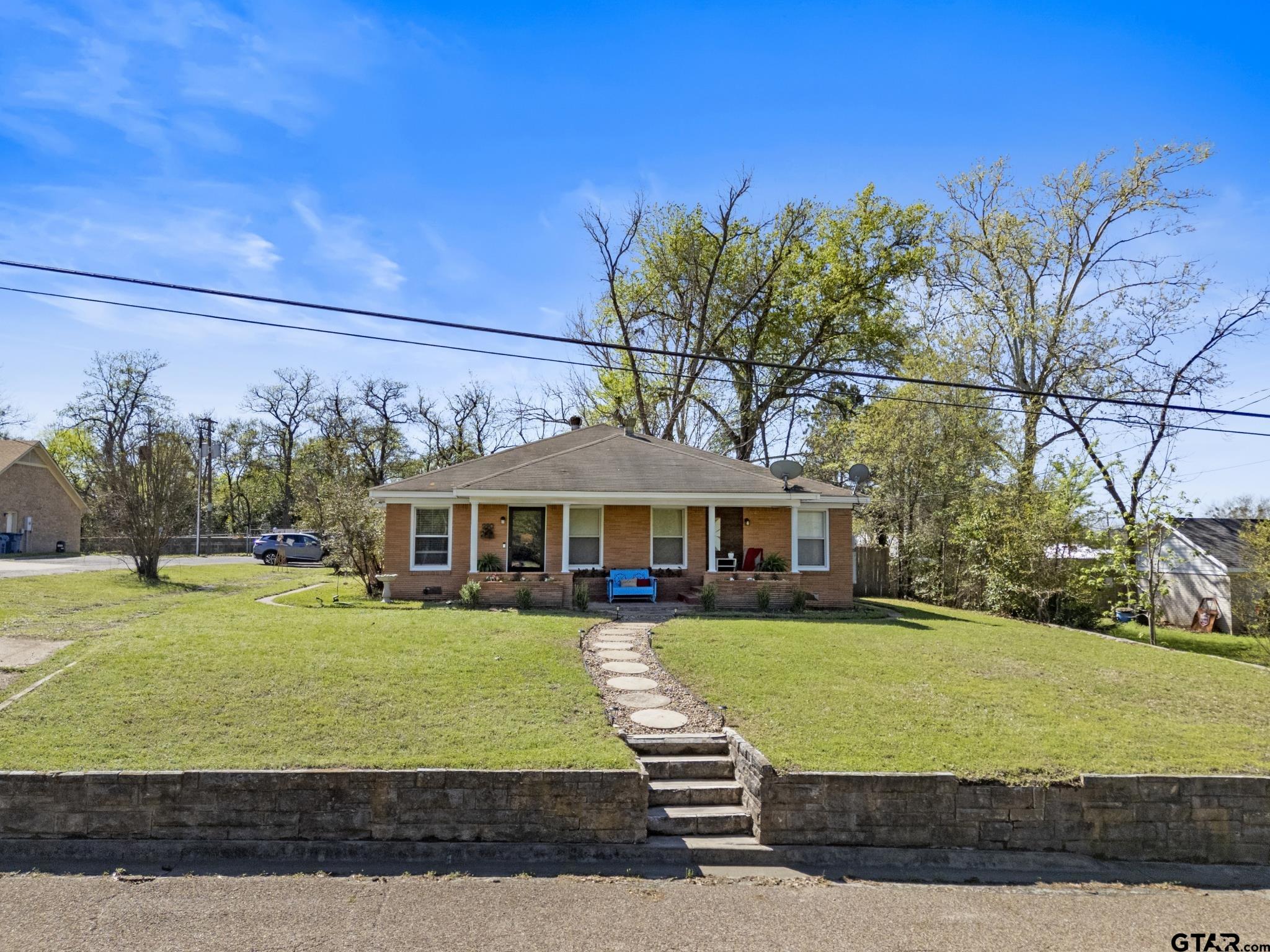 290 Lynch Street Hawkins, TX 75765 - Photo 3 of 36 a view of a big house with a big yard and large trees