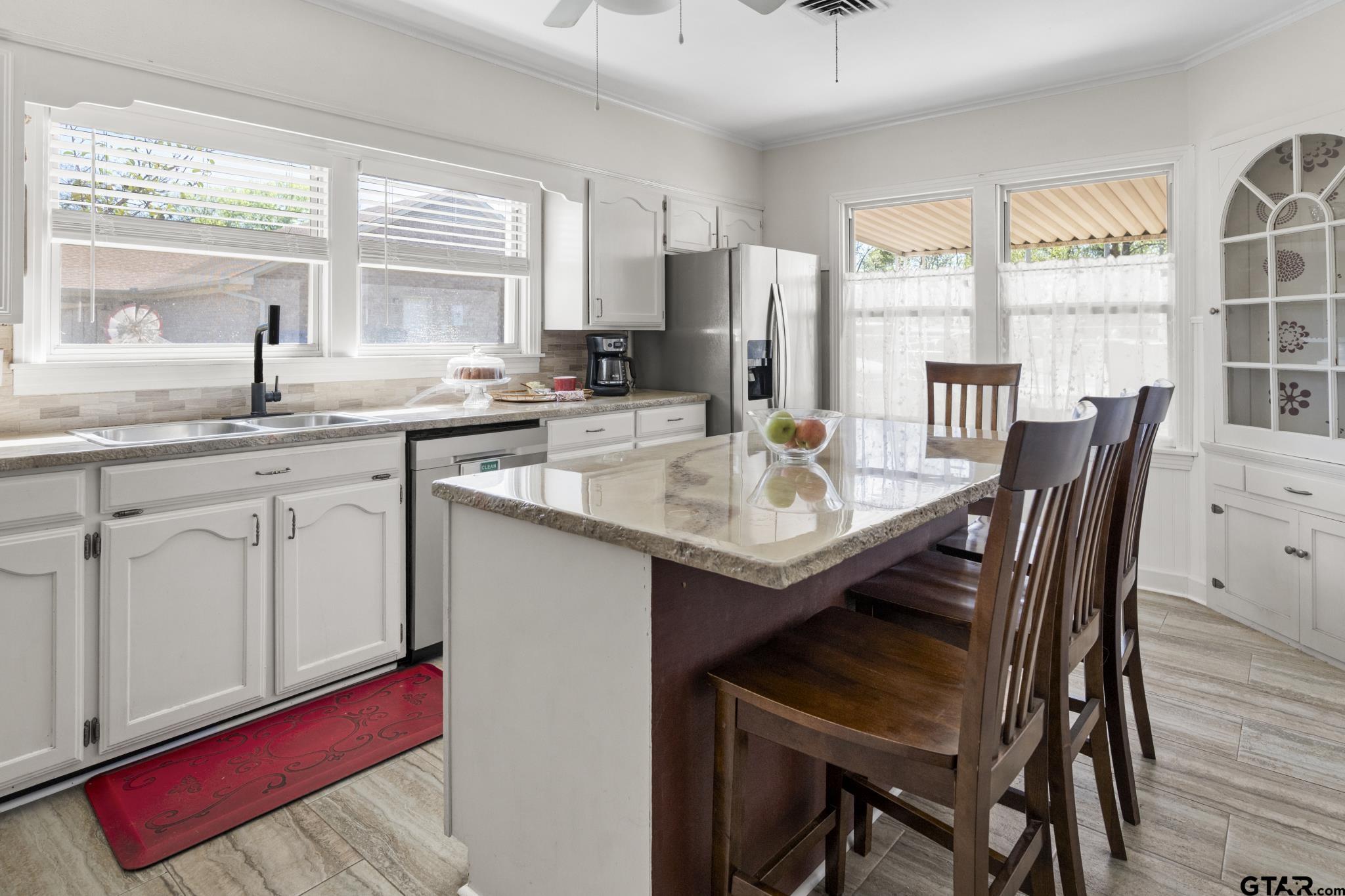 290 Lynch Street Hawkins, TX 75765 - Photo 9 of 36 a kitchen with stainless steel appliances granite countertop a dining table chairs and window