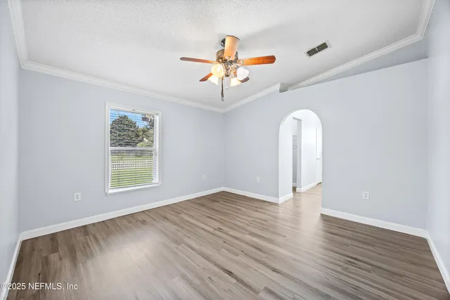 wooden floor in an empty room with a window