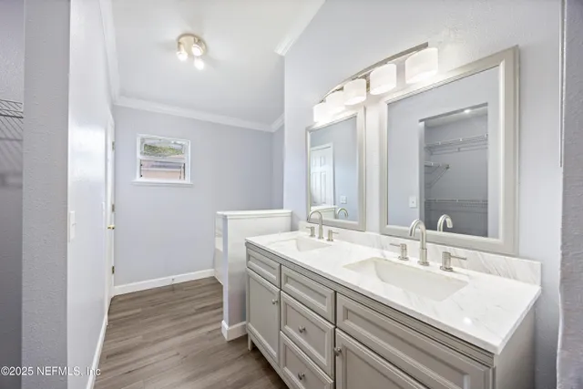 a bathroom with a sink double vanity and a mirror