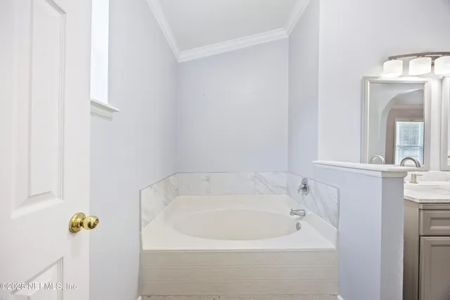 a white bath tub sitting next to a white sink