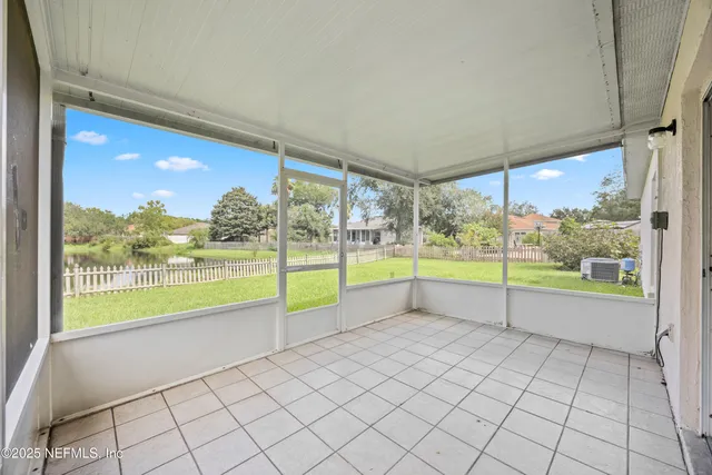a view of an empty room with a large window