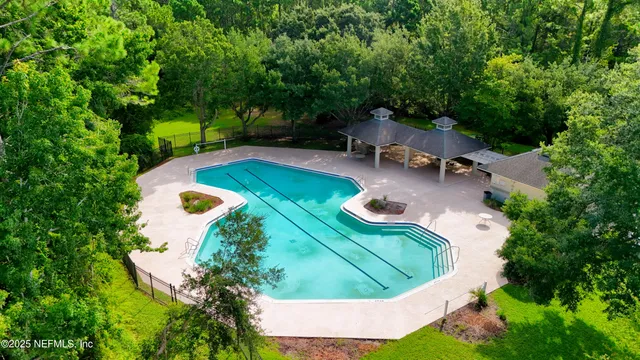 a view of a swimming pool with a yard
