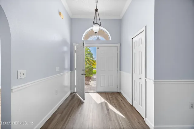 a view of hallway with wooden floor