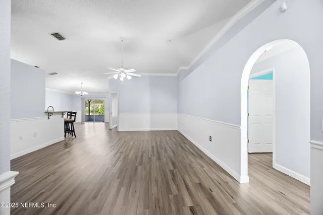 a view of a room with wooden floor