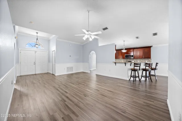 a view of a kitchen with furniture and wooden floor