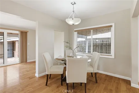 a dining room with furniture window and wooden floor
