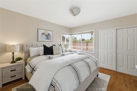 a bedroom with bed and a painting on the wall